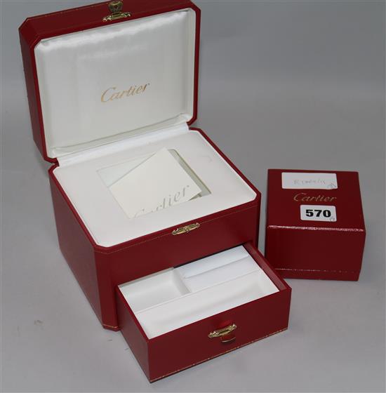 Two Cartier boxes.